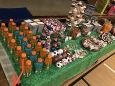 a table filled with lots of food and drinks on top of a green table cloth