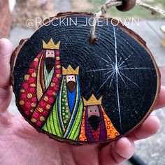 a hand painted wooden ornament with three wise men