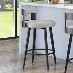 two modern bar stools in front of a counter