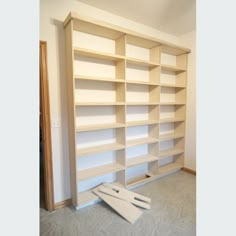 a large empty bookcase in the middle of a room