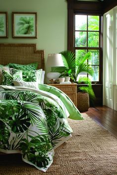 a bed with green leaves on it in a bedroom next to a lamp and window