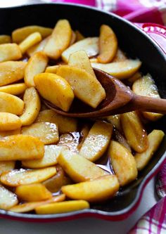 a skillet filled with cinnamon apples on top of a table