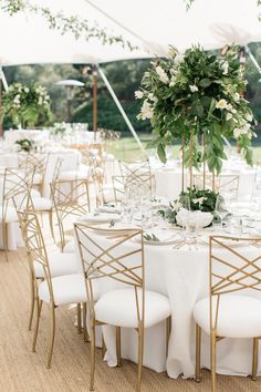 tables set up with white linens and gold chairs