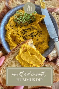 hummus dip in a blue bowl with bread on the side and a knife next to it