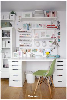 a white desk topped with lots of drawers next to a shelf filled with books and knick knacks