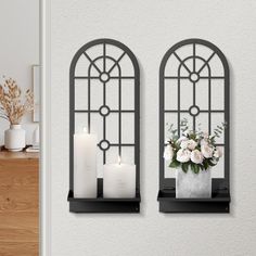 two windows with candles and flowers in them on the wall next to a vase filled with flowers