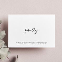 a close up of a card on a table next to some flowers and leaves with the word'finally'written in black ink