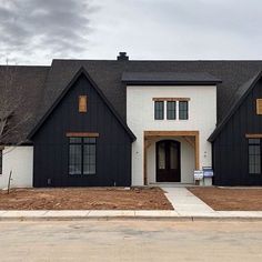 a black and white house with brown trim