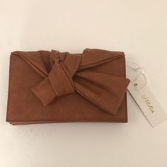 Brown Pu Leather Clutch With Ribbon Accent With Magnetic Snaps Trendy Brown Clutch For Party, Chic Brown Rectangular Wallet, Trendy Brown Clutch For Formal Occasions, Trendy Brown Clutch For Formal Events, Chic Orange Clutch For Everyday Use, Chic Orange Clutch, Brown Leather Clutch For Party, Brown Leather Party Clutch, Chic Brown Clutch For Gift