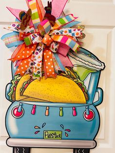 a door hanger with a taco truck on it's front and the words fiesta written in spanish