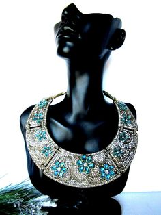 "Heidi Daus \"All that Glitter\" clear & blue crystal collar necklace - new * Brand - Heidi Daus * Design info - magnificent extravagant hinged collar is completely encrusted in crystals * Crystal info - shades of crystals include clear diamond, light black diamond and bright pops of blue topaz * This piece has stunning details including the swirling patterns created by the bronze tone metal, the stitched look of the connected plates and extreme sparkle and placement of each handset stone. * Nec Heidi Daus, Hook Clasp, All That Glitters, Light Black, Collar Necklace, Blue Crystals, Black Diamond, Blue Topaz, Crystal Necklace