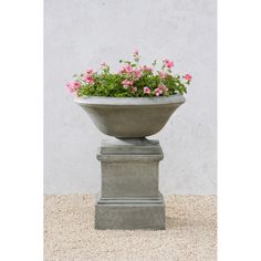 a cement planter with pink flowers in it