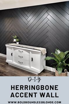 the herringbone accent wall is painted in black and white, with an old dresser next to it