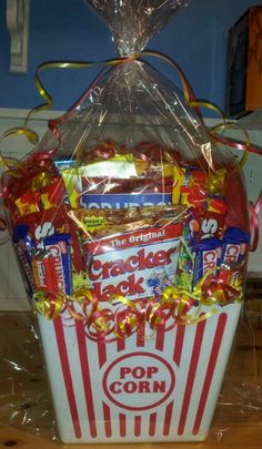 a popcorn bucket filled with snacks and candy