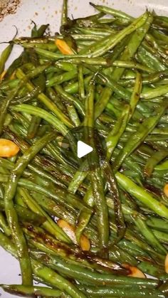 green beans are being cooked in a pan