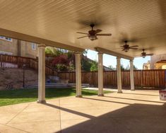 an outdoor covered patio with ceiling fans