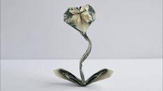 a flower made out of money sitting on top of a table