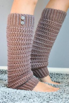 the legs of a woman wearing knitted leg warmers on top of carpeted floor