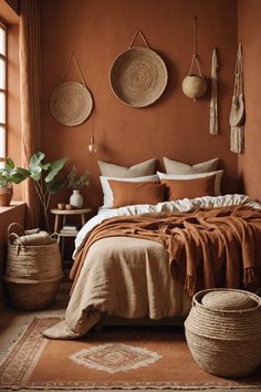 a bedroom with orange walls and brown linens on the bedspread, pillows and blankets