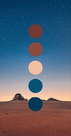 four circles are arranged in the middle of a desert landscape, with stars above them