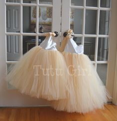 "Classic and beautiful, our one strap style tutu dress is made in a mix of ivory and our champagne/beige skirt. The top of the dress is FULLY LINED and the top of the strap opens to tie with a matching ribbon strap which ties at the right shoulder. The back of the dress is stretchy elastic along the top hem. We can make this dress in literally any color skirt (or even a mixture of colors). Convo us for questions. WANT A SEWN IN SLIP TO LINE THE TUTU? https://www.etsy.com/listing/125566641/add-a- Princess Style Cream Dress With Tulle Skirt, Cream Tulle Skirt Dress For Bridesmaid, Cream Tulle Tutu Dress For Bridesmaids, Cream Tulle Tutu Bridesmaid Dress, Cream Tulle Bridesmaid Tutu Dress, Elegant Cream Tutu Dress For Dress-up, Elegant Fitted Cream Tutu Dress, White Ballet Style Party Dress, Cream Tulle Tutu Dress For Wedding