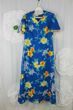 Vintage Made In Hawaii Blue Floral Hibiscus Mumu Dress Flutter Sleeve Size 10 Small stain on hem. Shown on photo Measurements on last photo. Approximate measurements taken with garment laying flat. Blue Hawaiian V-neck Dress, Blue Hawaiian Dress With Tropical Print, Blue Hibiscus Print Dress For Spring, Blue Spring Dress With Hibiscus Print, Spring Blue Dress With Hibiscus Print, Blue V-neck Hawaiian Dress, Blue Tropical Dress With Hibiscus Print, Blue Hibiscus Print Summer Dress, Summer Blue Dress With Hibiscus Print