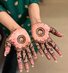 a woman's hands decorated with henna