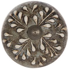 an old metal knob with white flowers on it