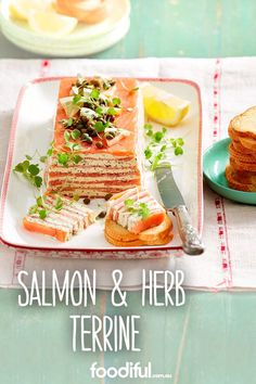 salmon and herb terrie on toasted bread with lemon wedges