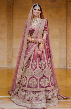 a woman in a red and gold bridal gown