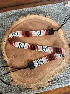 two black and white striped ties sitting on top of a wooden table