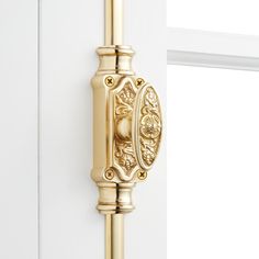 a gold door handle on a white door