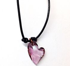 Add a pretty feminine Boho vibe to your look with this simple crystal heart necklace. A small purple-pink heart pendant dangling prettily from a small copper ring is the focal point of this leather necklace. To create this charming necklace, I united a  melody of black leather, copper, sterling silver, and a Swarovski Crystal heart pendant.   Also, heart jewelry makes a charming gift for any occasion. Product Details: - Materials: Swarovski Crystal, Leather, Copper - Clasp: Sterling Silver Lobst Simple Heart Necklace, Pink Heart Pendant, 15th Wedding Anniversary, Pink Heart Necklace, Black Leather Choker, Lavender Heart, Crystal Heart Necklace, Swarovski Crystal Hearts, Leather Choker Necklace