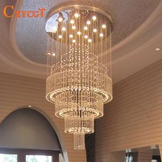 a large chandelier hanging from the ceiling in a room with white walls and flooring