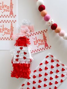 valentine's day crafts and decorations on a white table with red and pink hearts