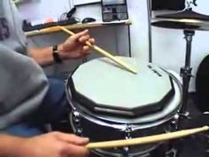 a man is playing drums in a recording studio