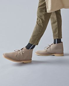 Our iconic Clarks Originals Desert Boots, crafted from soft sand suede. Designed in 1949 by Nathan Clark the Desert Boot was inspired by a rough boot from Cairo's Old Bazaar. An instant hit, it became the footwear choice for off-duty army officers. The suede is teamed with clean lines, an unfussy lace fastening and our signature crepe sole. #ClarksShoes #DesertBoot Workwear Leather Sole Chukka Boots, Workwear Ankle Lace-up Boots With Vibram Sole, Mens Prom Shoes, Workwear Lace-up Chukka Boots With Stitched Sole, Classic Chukka Boots With Rubber Sole, Almond Toe, Casual Lace-up Chukka Boots With Vibram Sole, Shoe Care Kit