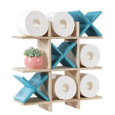 a wooden shelf holding several rolls of toilet paper