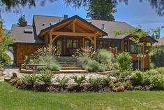 a large house with landscaping around the front yard and steps leading up to it's entrance