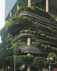 a very tall building with lots of plants growing on it