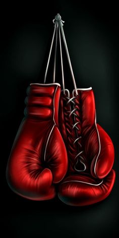 two red boxing gloves hanging from strings