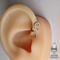 an ear is shown with a spiral design on it