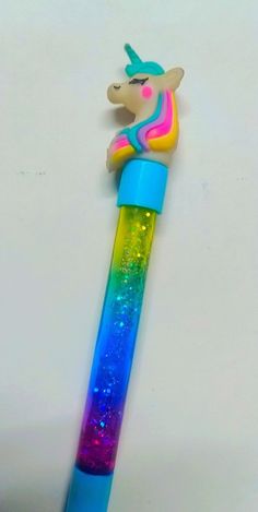 a colorful unicorn pen with glitter on it