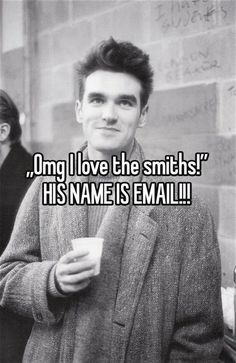 a man holding a cup with the words, i love the smiths his name is email