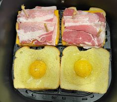 two eggs and bacon are on top of toast in a frying pan with water