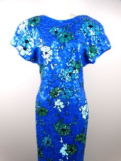 "This is a fully embellished vintage dress covered in bright blue and green sequins. The material is 96% cotton and 4% spandex, so there's is a little stretch in the material. It's in perfect condition! Measurements are taken not stretched and stretched: Size MEDIUM Measurements: Bust - 36-40\" Waist - 28-32\" Hips - 36-40\" Length - 43\" Size XL Measurements: Bust - 40-44\" Waist - 32-36\" Hips - 40-44\" Length - 43\" This dress comes from a pet-free and smoke-free home. If you would like more Iridescent Dress, Checkered Jacket, Sequined Dress, Sequin Jacket, Green Sequins, Bodycon Midi, Dress Cover, Embellished Dress, Large Size Dresses