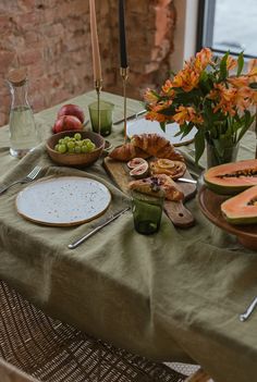 a table topped with lots of food next to a window