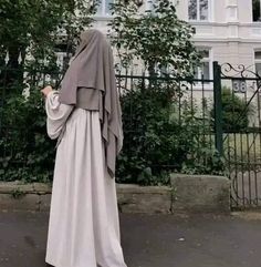 a woman in a nun outfit standing on the street