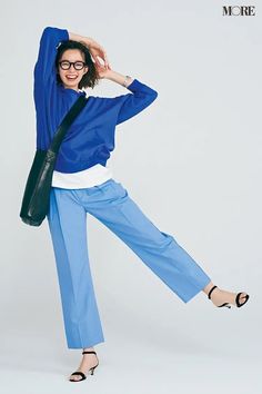 a woman in blue and white is posing for a photo