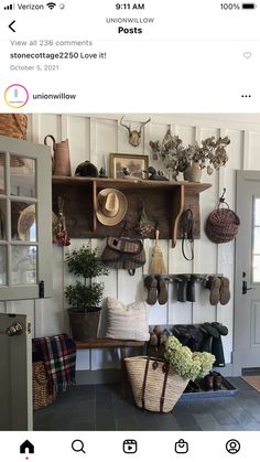 an entryway with baskets, hats and other items hanging on the wall above it